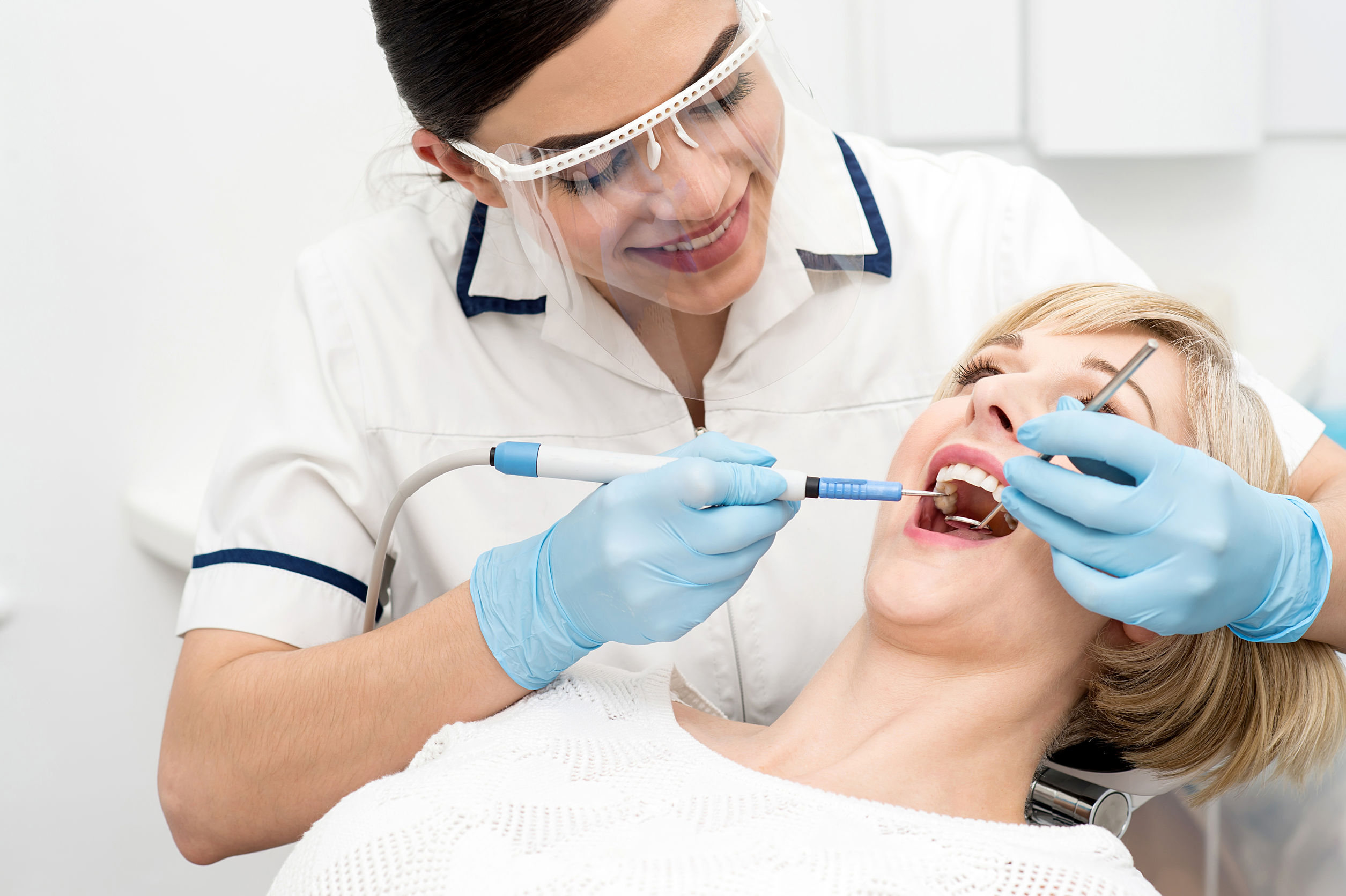 Dentist- Cleaning Patients Teeth